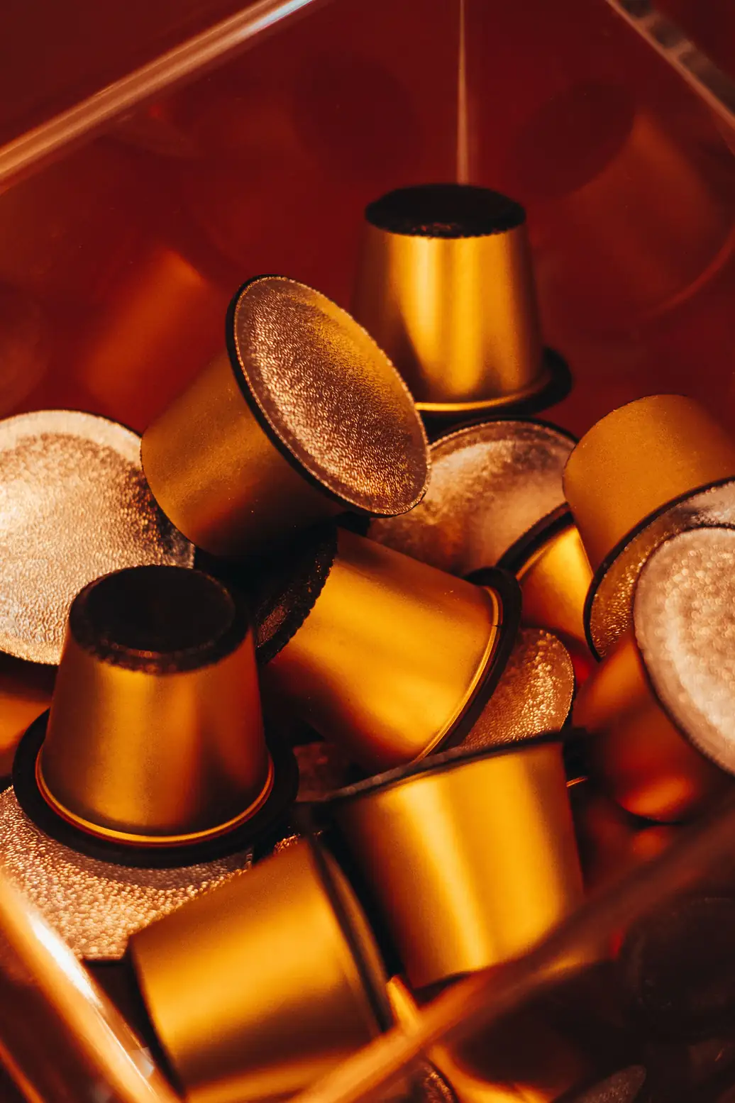 Close-up of gold-toned reusable coffee capsules