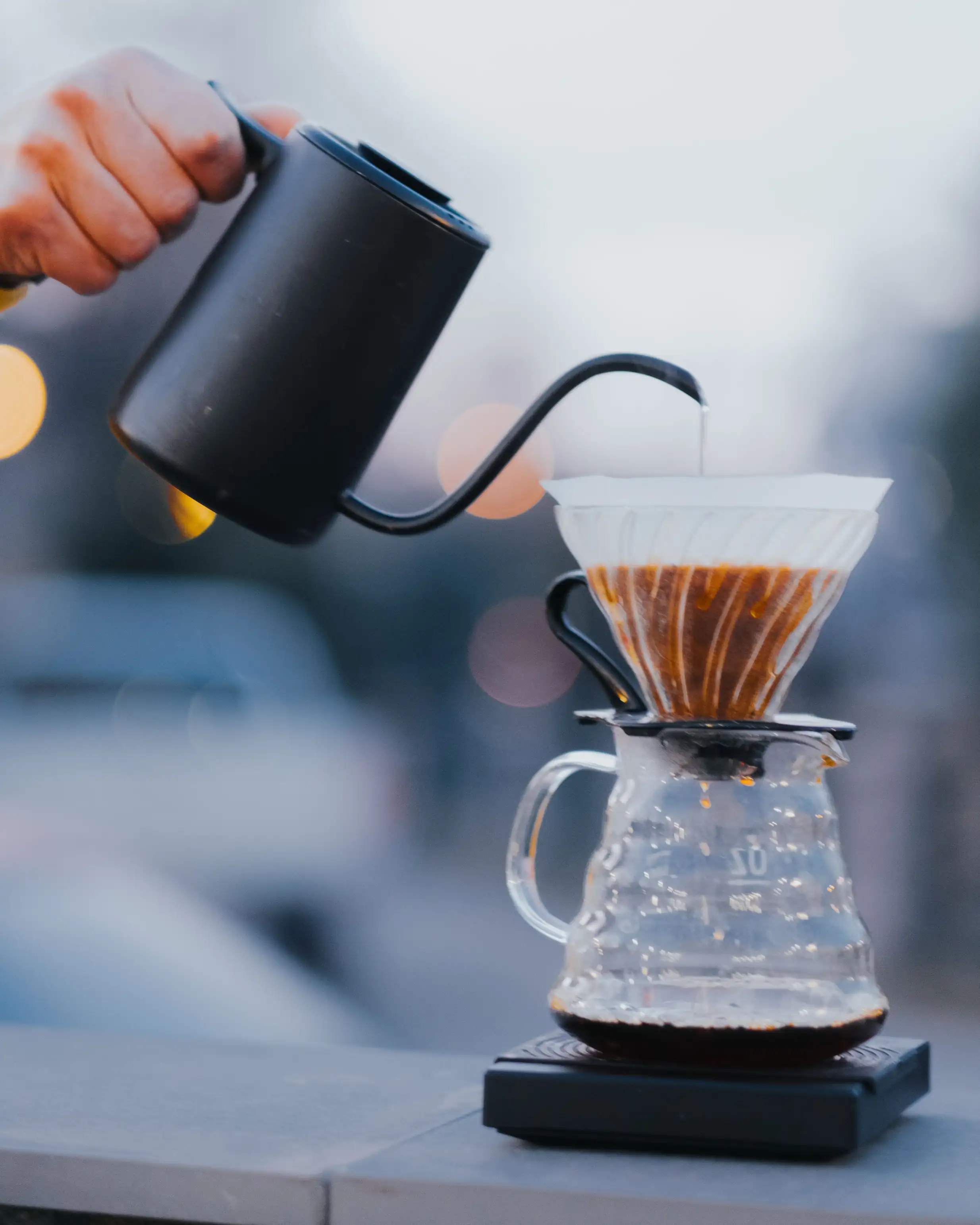 Pouring hot water over a V60 pour-over coffee dripper